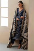 Woman wearing a patterned outfit with a large scarf in a minimalistic setting
